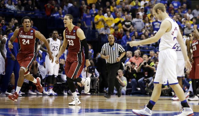 Stanford&#x27;s Josh Huestis (24) and Dwight Powell (33) celebrate as Kansas&#x27; Conner Frankamp, right, heads toward the sideline at the end of a third-round game of the NCAA college basketball tournament Sunday, March 23, 2014, in St. Louis. Stanford won 60-57. (AP Photo/Jeff Roberson)