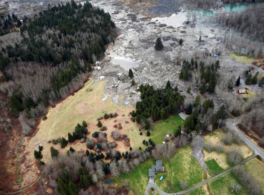 This March 23, 2014 photo, made available by the Washington State Dept of Transportation shows a view of the damage from Saturday's mudslide in Oso, Wash. At least eight people were killed in the 1-square-mile slide that hit in a rural area about 55 miles northeast of Seattle on Saturday. Several people also were critically injured, and about 30 homes were destroyed. (AP Photo/Washington State Dept of Transportation)