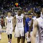 Kansas players walk off the court following their loss in a third-round game against Stanford at the NCAA college basketball tournament Sunday, March 23, 2014, in St. Louis. Stanford won the game 60-57. (AP Photo/Charlie Riedel)