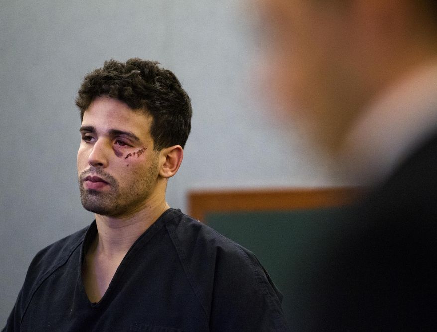 Joey Kadmiri awaits his arraignment at the Clark County Regional Justice Center in Las Vegas Township Justice Court, Monday, March 24, 2014. Kadmiri is accused of firing a gun during a backstage robbery attempt in the Thunder From Down Under dressing area. (AP Photo/Las Vegas Sun, L.E. Baskow)