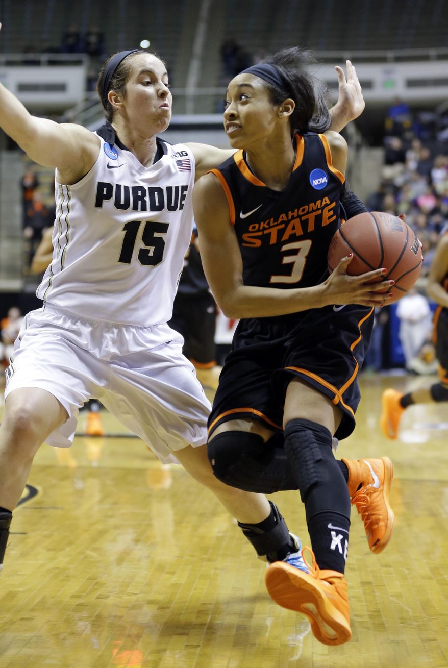 Oklahoma State guard Tiffany Bias, right, drives on Purdue guard Courtney Moses during the first half of a women's second round NCAA tournament college basketball game in West Lafayette, Ind., Monday, March 24, 2014. (AP Photo/Michael Conroy)