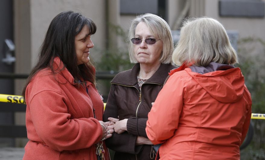Barbara Welsh, center, whose husband is missing in a deadly mudslide, stands with relatives Monday, March 24, 2014, in Arlington, Wash. The search for survivors of the deadly mudslide grew Monday to include 108 names of people who were reported missing or were unaccounted for, but authorities cautioned the figure would likely decline dramatically. The size of the list raised concerns the death toll would rise far above the eight people who have been confirmed dead after the 1-square-mile (2.6-square-kilometer) slide Saturday swept through part of a former fishing village about 55 miles (80 miles) northeast of Seattle. Several people also were critically injured. About 30 homes were destroyed, and the debris blocked a 1-mile (1.6 kilometer) stretch of state highway. (AP Photo/Elaine Thompson)