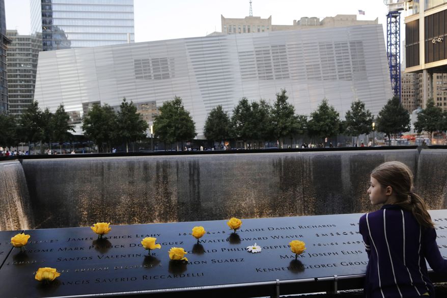 FILE - Charlotte Newman, 8, visits the National September 11 Memorial and Museum, Sunday, Sept. 8, 2013 in New York. The long-awaited museum dedicated to the victims of the Sept. 11 terror attacks will open to the public at the World Trade Center site on May 21, officials announced Monday, March 24, 2014. (AP Photo/Mark Lennihan, File)