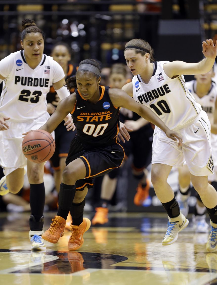 Oklahoma State guard Roshunda Johnson heads up court after making a steal in front of Purdue forward Liza Clemons (23) and guard Hayden Hamby (10) during the first half of a women's second round NCAA tournament college basketball game in West Lafayette, Ind., Monday, March 24, 2014. (AP Photo/Michael Conroy)