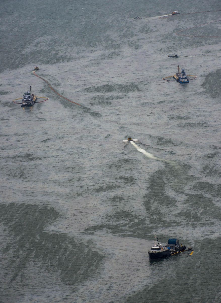 Vessels work with skimmers and oil containment booms in Galveston Harbor on Sunday, March 23, 2014, in Galveston. Dozens of ships are in evolved in clean-up efforts to remove up to 168,000 gallons of oil that make have spilled into Galveston Bay after a ship and barge collided near the Texas City dike on Saturday afternoon. (AP Photo/Houston Chronicle, Smiley N. Pool)