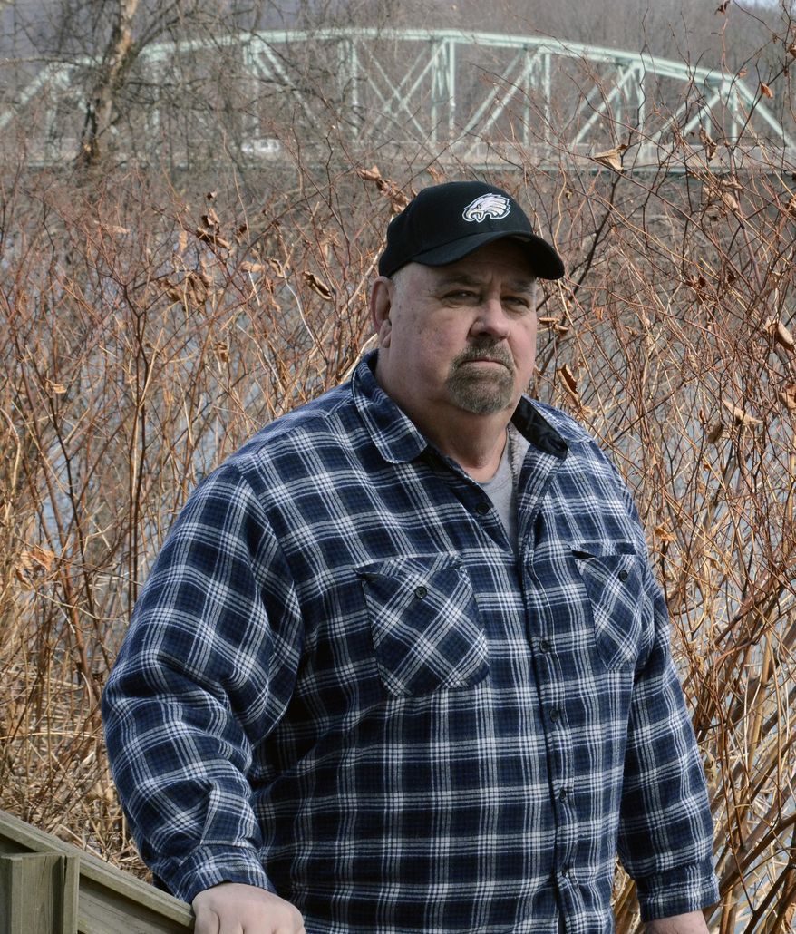 Paul Garrett stands on a stairway in front of his house which leads down to the banks of the Susquehanna River in Jersey Shore, Pa. on Sunday, March 23, 2014. About a third of the borough (population 4,300) is in a flood hazard zone. Nearly 470 homes in town are expected to see flood insurance premium hikes. (AP Photo/Ralph Wilson)
