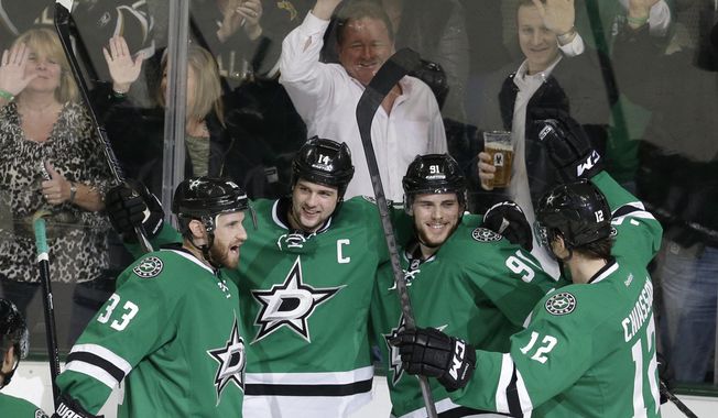 Dallas Stars center Tyler Seguin (91) celebrates scoring his goal with teammates  Alex Goligoski (33), Jamie Benn (14) and Alex Chiasson (12) during the second period of an NHL hockey game against the Winnipeg Jets Monday, March 24, 2014, in Dallas. (AP Photo/LM Otero)