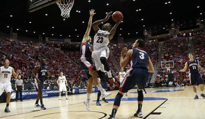 Arizona forward Rondae Hollis-Jefferson (23) shoots over Gonzaga forward Drew Barham during the first half of a third-round game in the NCAA college basketball tournament Sunday, March 23, 2014, in San Diego. (AP Photo/Lenny Ignelzi)