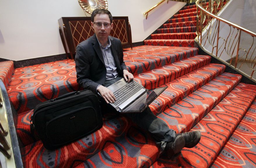 **FILE** Statistician Nate Silver sits on the stairs at Allegro hotel in downtown Chicago on Nov. 9, 2012. (Associated Press)