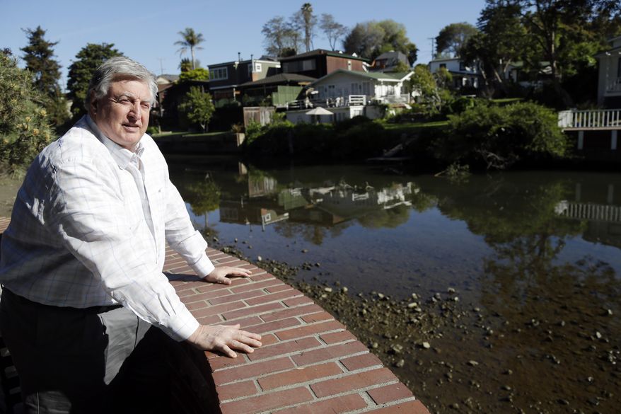 Ted Burke, co-owner Shadowbrooke restaurant, looks out unto Soquel Creek on Wednesday, March 19, 2014, in Capitola , Calif. The historic community of 10,000, locally known as the Jewel Box for it’s cute boutiques, galleries, coffee shops and ocean front dining, sits smack in the middle of two different floodplains. Soquel Creek is more of a river than a creek in wet winters when it storms through downtown Capitola, a rage of muddy water, fallen trees and debris after a 16 mile run through the Santa Cruz Mountains to the Monterey Bay. (AP Photo/Marcio Jose Sanchez)