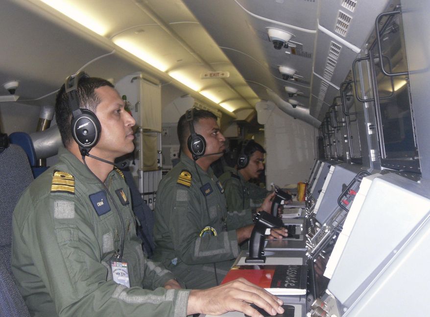 This Sunday, March 23, 2014 photo released by the Indian Navy, shows the navy personnel on board a P-8I aircraft during a search operation for the missing Malaysia Airlines flight MH370 aircraft in the southern Indian Ocean. Ships rushed to the location of floating objects spotted Monday by Australian and Chinese planes in the southern Indian Ocean close to where multiple satellites have detected possible remains of the lost Malaysian airliner. (AP Photo/Indian Navy)