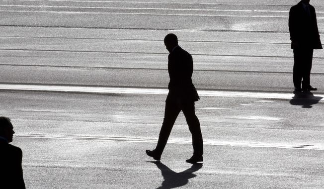 President Barack Obama, center, and two secret service agents are silhouetted as he walks toward Marine One helicopter upon arrival at Schiphol Amsterdam Airport, Netherlands, Monday March 24, 2014. Obama will attend the two-day Nuclear Security Summit in The Hague. (AP Photo/Peter Dejong, POOL)