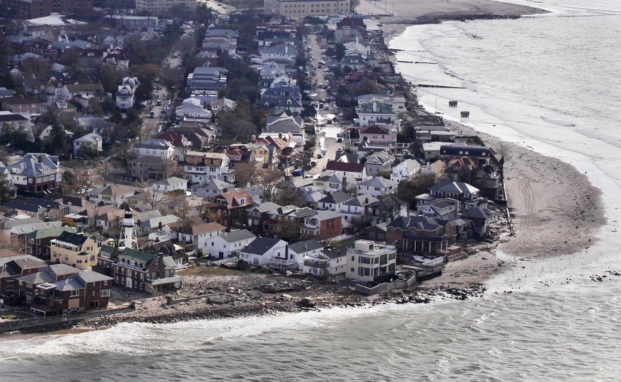 This Oct. 31, 2012 aerial photo shows the oceanfront community of Sea Gate in the Queens borough of New York. While President Barack Obama signed a law Friday, March 21, 2014 that will delay steep increases to flood insurance paid by many, nearly 60,000 policyholders in New York state are among the 1.1 million nationwide who will see their federally subsidized flood insurance premiums rise as part of changes to the National Flood Insurance Program, according to a review of federal data by The Associated Press. (AP Photo/Mark Lennihan)