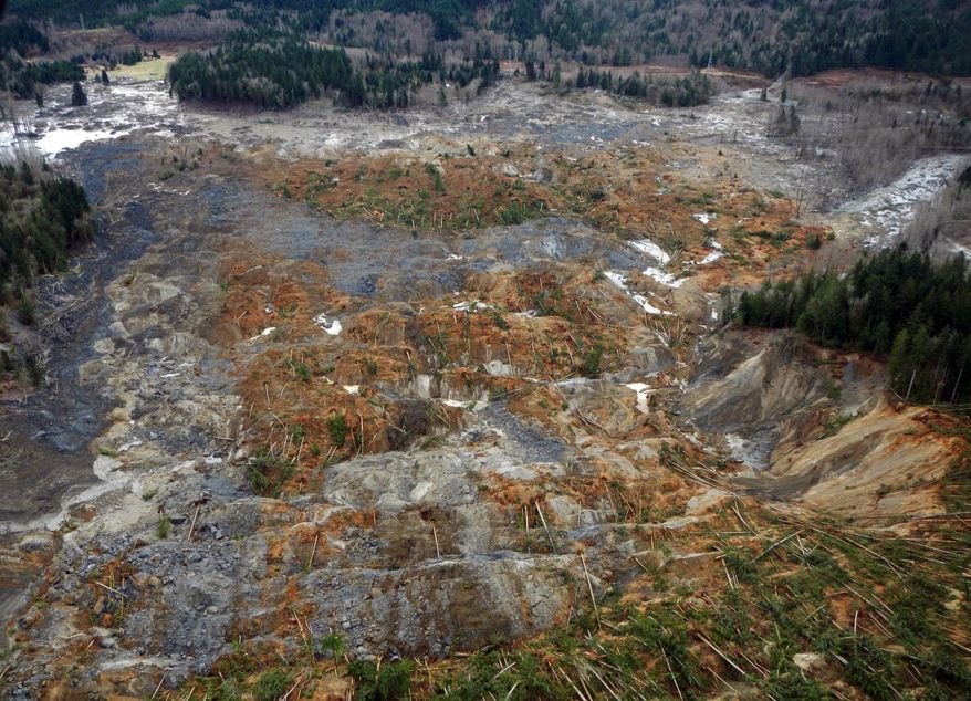This March 22, 2014 photo, made available by the Washington State Dept of Transportation shows a view of the damage from Saturday's mudslide in Oso, Wash. At least eight people were killed in the 1-square-mile slide that hit in a rural area about 55 miles northeast of Seattle on Saturday. Several people also were critically injured, and about 30 homes were destroyed. (AP Photo/Washington State Dept of Transportation)