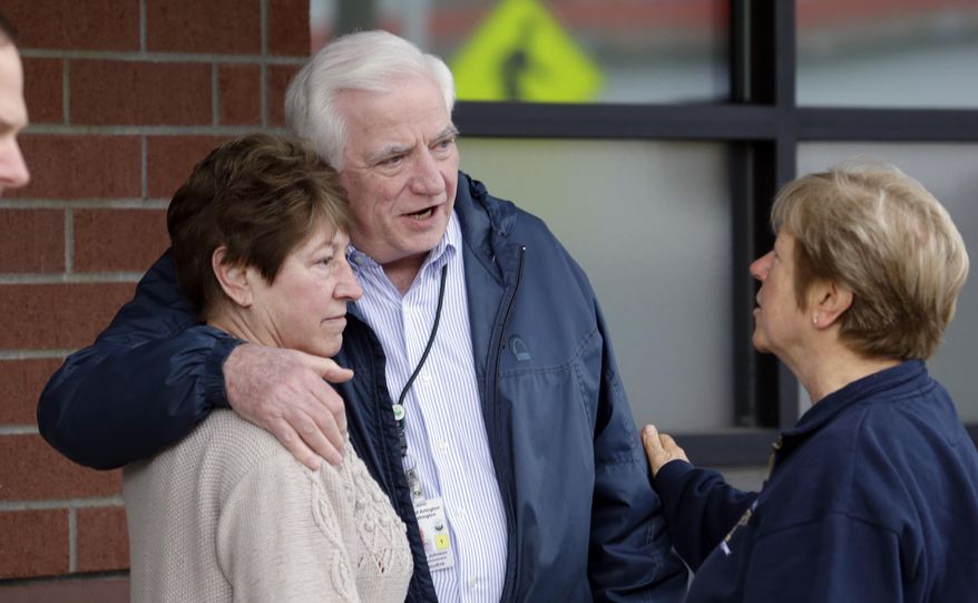 Allen Johnson, center, Arlington City Manager, stands with city council member Jan Schuette, left, and former council member Linda Byrnes after listening in on a news conference about a deadly mudslide Monday, March 24, 2014, in Arlington, Wash. The search for survivors of the deadly mudslide grew Monday to include 108 names of people who were reported missing or were unaccounted for, but authorities cautioned the figure would likely decline dramatically. The size of the list raised concerns the death toll would rise far above the eight people who have been confirmed dead after the 1-square-mile (2.6-square-kilometer) slide Saturday swept through part of a former fishing village about 55 miles (80 miles) northeast of Seattle. Several people also were critically injured. About 30 homes were destroyed, and the debris blocked a 1-mile (1.6 kilometer) stretch of state highway. (AP Photo/Elaine Thompson)