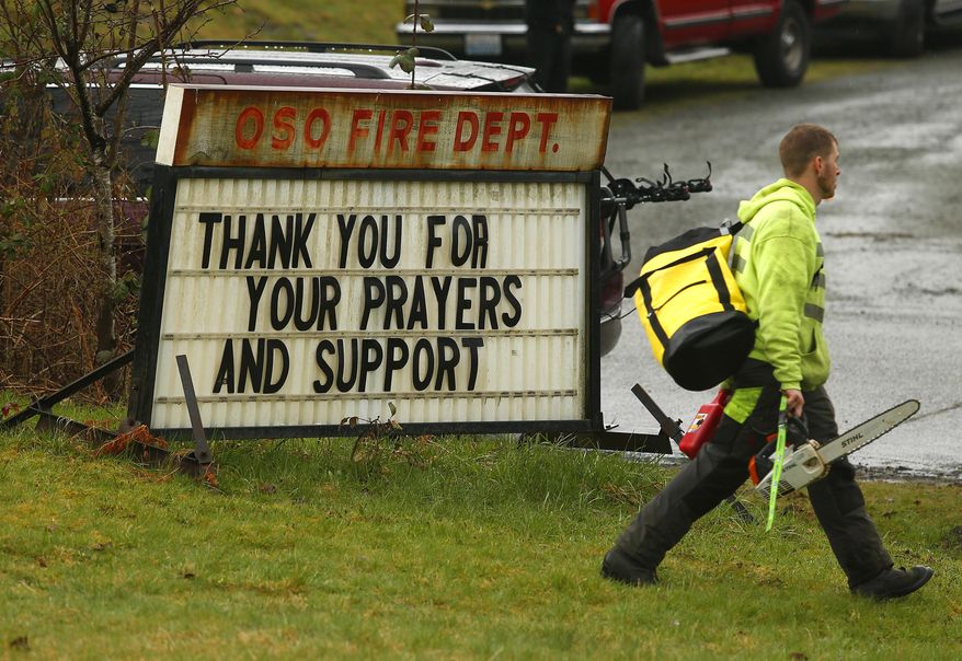 Volunteers arrive at the Oso Fire Department, Tuesday, March 25, 2014, in Oso, Wash. A massive mudslide struck near Arlington, Wash., on Saturday. At least 14 people were killed over the weekend and scores more missing. (AP Photo/The Herald, Mark Mulligan)