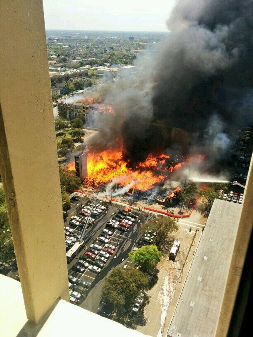 In this photo provided by Christopher Laski a large apartment complex under construction is consumed by fire, sending black smoke billowing into the sky and drawing hundreds of emergency personnel, Tuesday, March 25, 2014, in Houston. Houston fire officials say no injuries have been reported as a result of the dramatic blaze first reported about 12:30 p.m. Tuesday. (AP Photo/ Christopher Laski)