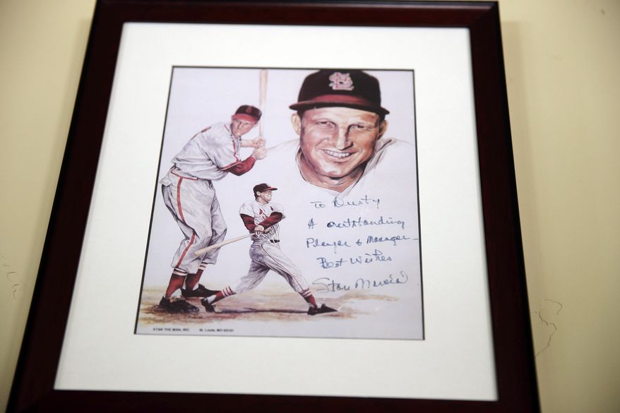 In this March 13, 2014 photo, a framed and signed picture from Stan Musial hangs on a wall at Dusty Baker&#39;s home in Granite Bay, Calif. Out of uniform for the first time since taking 2007 off between managerial jobs with the Cubs and Reds, Baker is not slowing down much from his pressure-packed days in the dugout. (AP Photo/Eric Risberg)