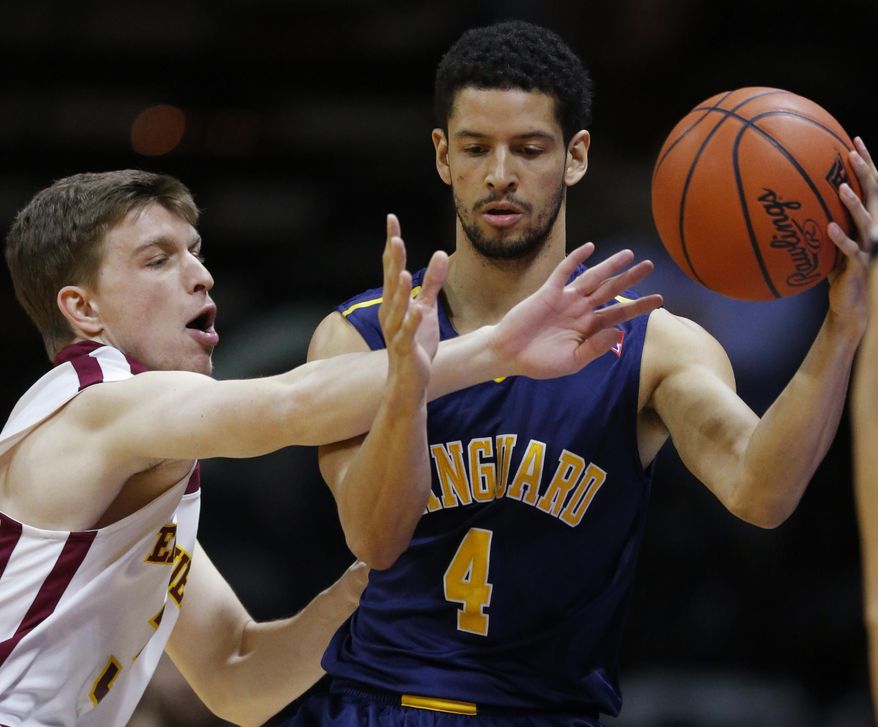 Emmanuel guard Luke Miller, left, reaches in on Vanguard guard Preston Wynne (4) during the first half of an NAIA college basketball game and finals of the men's national championship tournament in Kansas City, Mo., Tuesday, March 25, 2014. (AP Photo/Orlin Wagner)