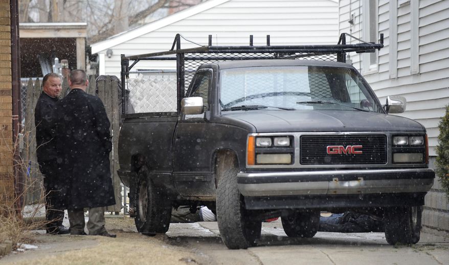 Authorities investigate the scene where two men were shot to death during an apparent burglary in Detroit, Tuesday, March 25, 2014. Detroit Police Sgt. Michael Woody told The Detroit News and WWJ-AM that officers found the men dead in the driveway after responding Tuesday to a report of shots fired. (AP Photo/Detroit News, David Coates) DETROIT FREE PRESS OUT; HUFFINGTON POST OUT
