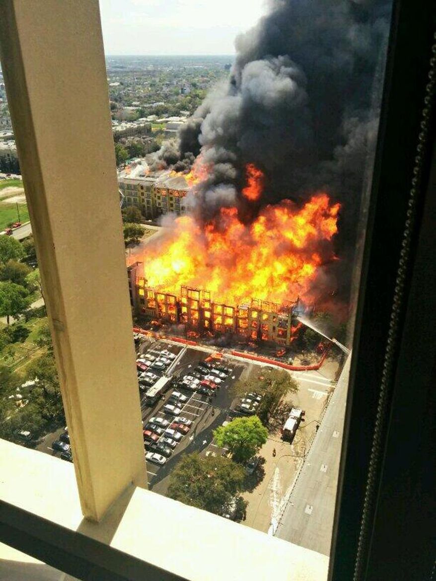 In this photo provided by Christopher Laski a large apartment complex under construction is consumed by fire, sending black smoke billowing into the sky and drawing hundreds of emergency personnel, Tuesday, March 25, 2014, in Houston. Houston fire officials say no injuries have been reported as a result of the dramatic blaze first reported about 12:30 p.m. Tuesday. (AP Photo/ Christopher Laski)