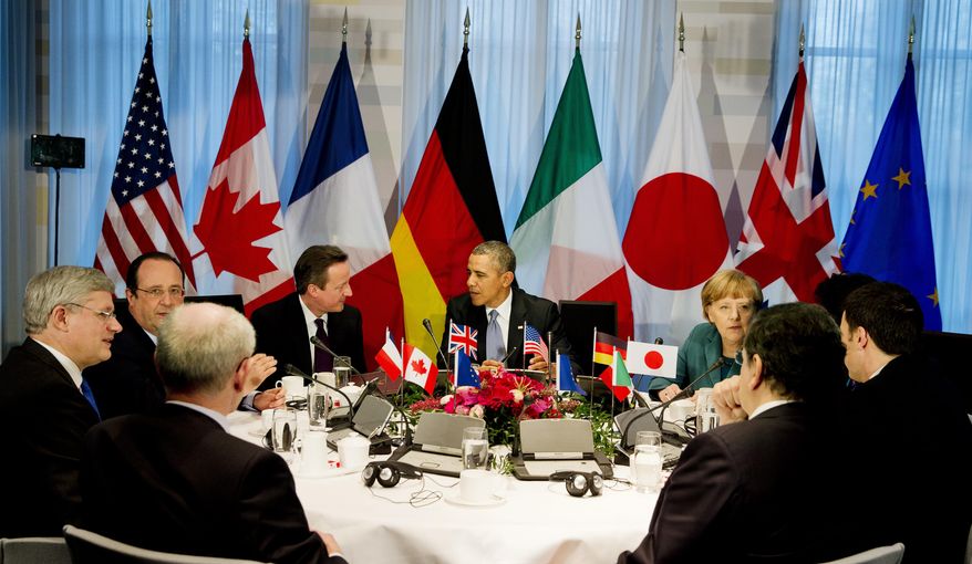 President Barack Obama, center rear, gathered with G7 world leaders clockwise from center left, European Council president Herman Van Rompuy, Canadian Prime Minister Stephen Harper, French President Francois Hollande, British Prime Minister David Cameron, US President Barack Obama, German Chancellor Angela Merkel, Japanese Prime Minister Shinzo Abe, Italian Prime Minister Matteo Renzi and European Commission president Jose Manuel Barroso, in The Hague, Netherlands, Monday March 24, 2014, in the sidelines of the Nuclear security Summit. In a day of delicate diplomacy he sought to rally the international community Monday around efforts to isolate Russia following its incursion into Ukraine. Nuclear terrorism was the official topic as Obama and other world leaders streamed in to a convention center in The Hague for a two-day Nuclear Security Summit. But the real focus was on a hurriedly scheduled meeting of the Group of Seven industrialized economies to address the crisis in Ukraine on the sidelines of the nuclear summit. (AP Photo/Jerry Lampen, POOL)