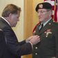 U.S. Congressman Mike Rogers pins the Bronze Star Medal with Valor on PFC Andrew Kach, who served in the Vietnam war, in a ceremony at the American Spirit Centre, Monday, March 17, 2014. (AP Photo/Livingston County Daily Press &amp;amp; Argus, Gillis Benedict)