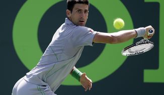 Novak Djokovic, of Serbia, returns to Tommy Robredo, of Spain, at the Sony Open Tennis tournament, Tuesday, March 25, 2014, in Key Biscayne, Fla. (AP Photo/Lynne Sladky)