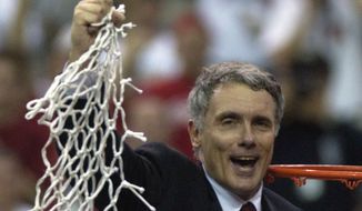 Maryland coach Gary Williams swings the net after his Terps beat Indiana 64-52 in the NCAA final in Atlanta Monday, April 1, 2002. (AP Photo/John Bazemore)