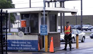 FILE - In this May 3, 2004 file photo, security personnel wait to inspect vehicles entering Norfolk Naval Station in Norfolk, Va. A sailor was fatally shot at the world&#39;s largest naval base late Monday, March 24, 2014, and security forces killed a male civilian suspect, base spokeswoman Terri Davis said. (AP Photo/The Virginian-Pilot, Mort Fryman)