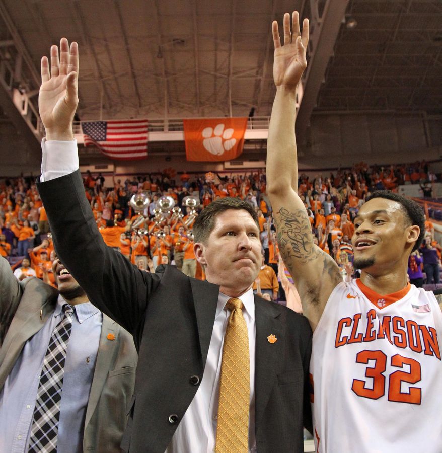 Clemson head coach Brad Brownell, left and K.J. McDaniels celebrate with fans after their 73-68 win over Belmont in an NCAA college basketball National Invitational Tournament quarterfinal game at Littlejohn Coliseum in Clemson, S.C., on Tuesday, Mar. 25, 2014. (AP Photo/Anderson Independent-Mail, Mark Crammer)