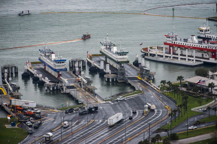 In this photo taken on Sunday, March 23, 2014, oil containment booms are spread out near the idle Galveston-Bolivar Ferry terminal in Galveston, Texas. The Coast Guard partially reopened one of the nation's busiest seaports to ship traffic Tuesday, March 25, three days after a collision between a barge and a ship spilled up to 170,000 gallons of tar-like oil into the waters south of Houston. (AP Photo/Houston Chronicle, Smiley N. Pool)  MANDATORY CREDIT