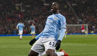 Manchester City&#x27;s Yaya Toure celebrates after scoring against Manchester United during their English Premier League soccer match at Old Trafford Stadium, Manchester, England, Tuesday, March 25, 2014. (AP Photo/Jon Super)