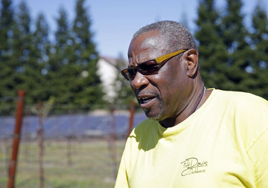 In this March 13, 2014 photo, Dusty Baker stands in his vineyard while talking about his future at his home in Granite Bay, Calif. While his former players and fellow managers are busy preparing for opening day, Baker is busy tending to his crops and minding his vineyard and the several hybrid fruit trees that border it. Out of uniform for the first time since taking 2007 off between managerial jobs with the Cubs and Reds, Baker is not slowing down much from his pressure-packed days in the dugout. (AP Photo/Eric Risberg)