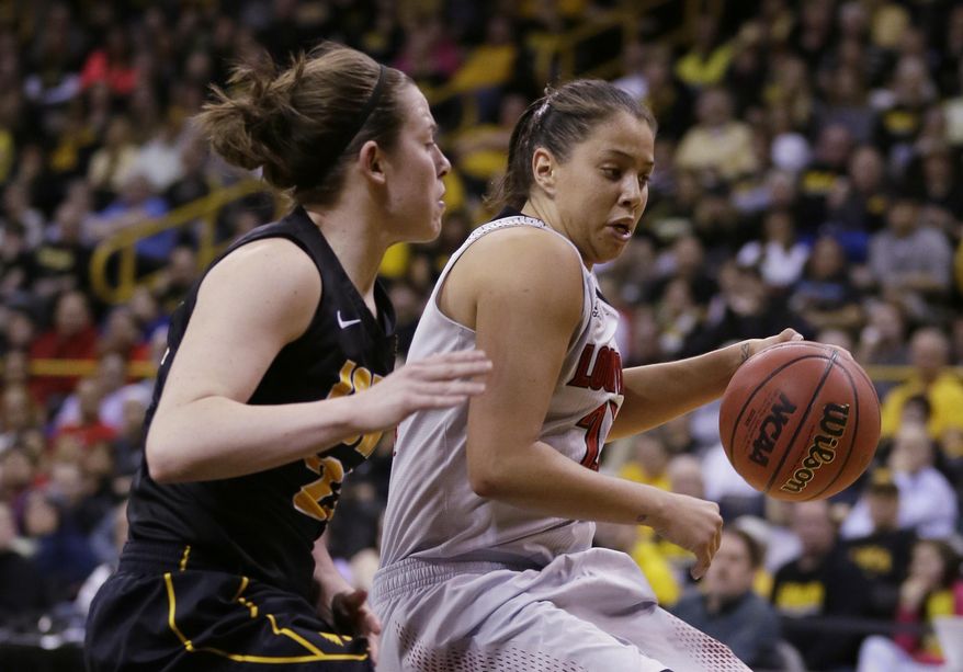 Louisville guard Shoni Schimmel, right, drives past Iowa guard Samantha Logic during the second half of an NCAA tournament second-round women's college basketball game, Tuesday, March 25, 2014, in Iowa City, Iowa. (AP Photo/Charlie Neibergall)