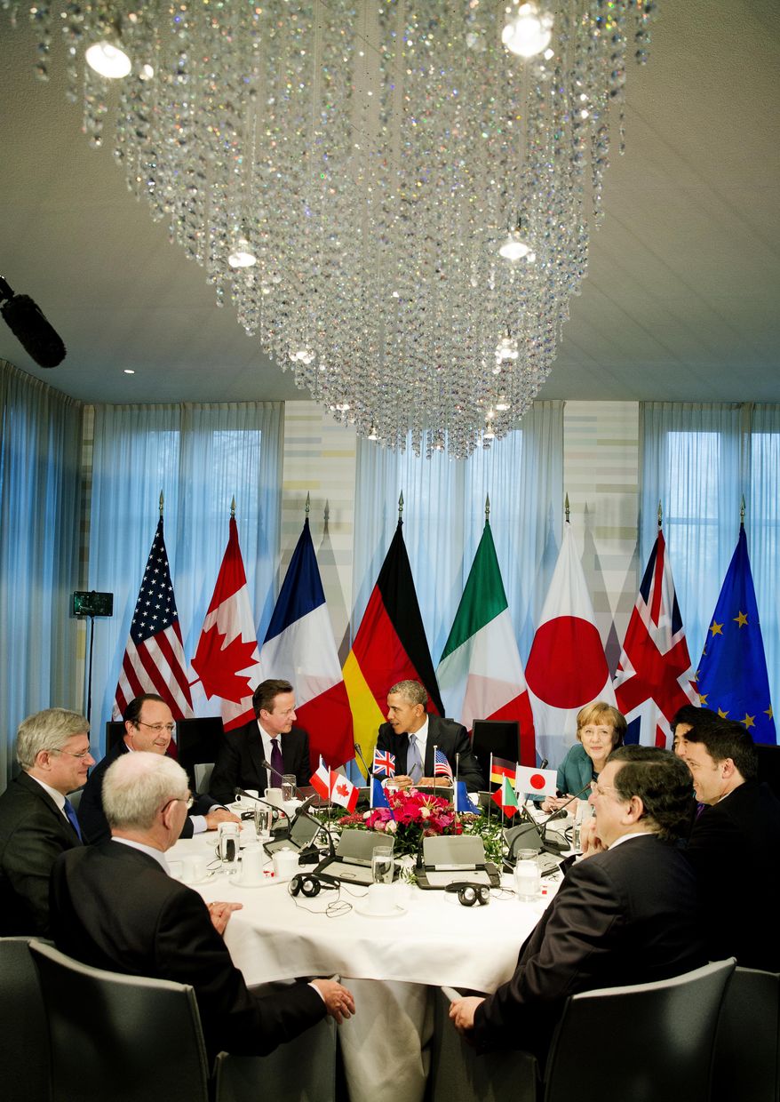 President Barack Obama, center rear, gathered with G7 world leaders clockwise from center left, European Council president Herman Van Rompuy, Canadian Prime Minister Stephen Harper, French President Francois Hollande, British Prime Minister David Cameron, US President Barack Obama, German Chancellor Angela Merkel, Japanese Prime Minister Shinzo Abe, Italian Prime Minister Matteo Renzi and European Commission president Jose Manuel Barroso, in The Hague, Netherlands, Monday March 24, 2014, in the sidelines of the Nuclear security Summit. In a day of delicate diplomacy he sought to rally the international community Monday around efforts to isolate Russia following its incursion into Ukraine. Nuclear terrorism was the official topic as Obama and other world leaders streamed in to a convention center in The Hague for a two-day Nuclear Security Summit. But the real focus was on a hurriedly scheduled meeting of the Group of Seven industrialized economies to address the crisis in Ukraine on the sidelines of the nuclear summit. (AP Photo/Jerry Lampen, POOL)