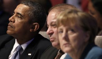 U.S. President Barack Obama, left, Pakistan&#39;s Prime Minister Mohammad Nawaz Sharif, center, and German Chancellor Angela Merkel, attend the opening session of the Nuclear Summit in The Hague, the Netherlands, on Monday, March 24, 2014. (AP Photo/Yves Herman, POOL)