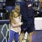 Dayton head coach Archie Miller watches practice with his daughter Leah Grace at the NCAA college basketball tournament, Wednesday, March 26, 2014, in Memphis, Tenn. Dayton plays Stanford in a regional semifinal on Thursday. (AP Photo/Mark Humphrey)