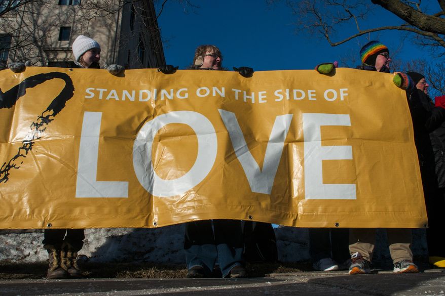 Supporters hold up a banner during a pro-gay marriage rally held by the Unitarian Universalist Church of Flint on Wednesday, March 26, 2014, outside of the Genesee County Courthouse in Flint, Mich. A federal appeals court Tuesday put an indefinite halt to gay marriage in Michigan while it takes a longer look at the decision overturning a 2004 ban. (AP Photo/The Flint Journal, Jake May) LOCAL TV OUT; LOCAL INTERNET OUT