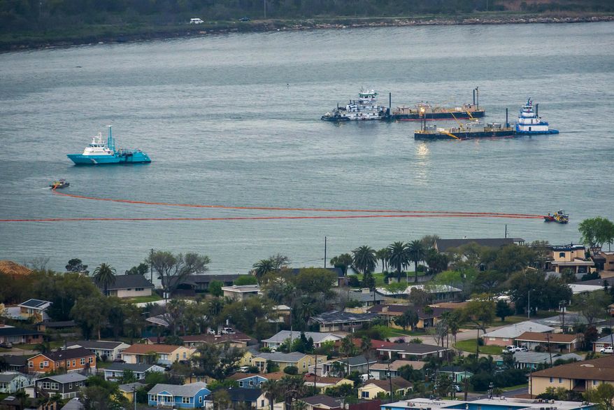 Oil containment booms are spread out in Galveston Harbor on Sunday, March 23, 2014, in Galveston. Dozens of ships are in evolved in clean-up efforts to remove up to 168,000 gallons of oil that make have spilled into Galveston Bay after a ship and barge collided near the Texas City dike on Saturday afternoon. (AP Photo/ Houston Chronicle, Smiley N. Pool)
