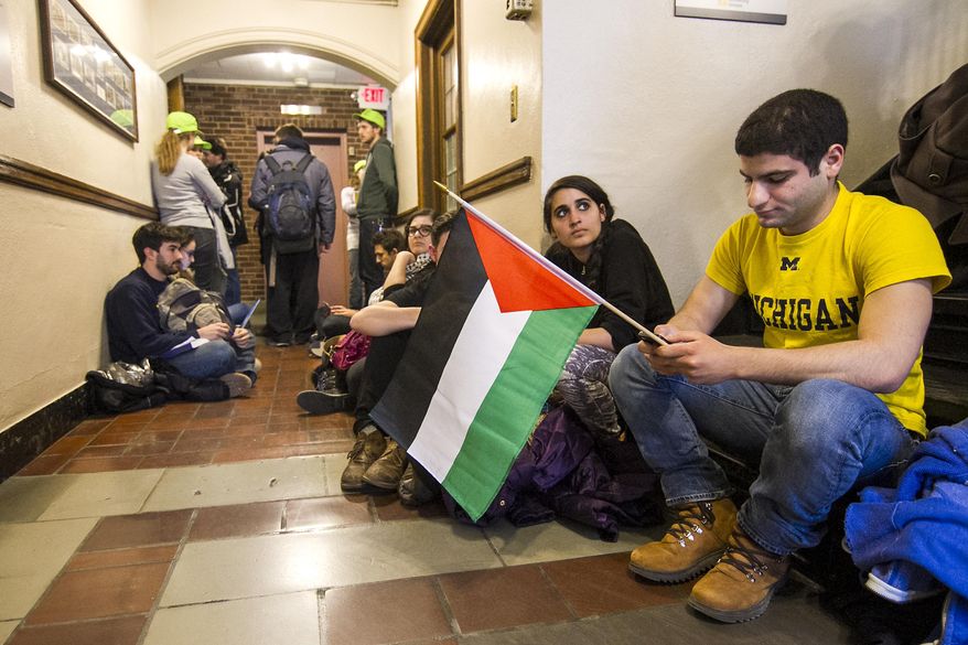 Ahmed Elbatron Graduate student at the University of Michigan waits in line with other students before being let into the meeting on Tuesday March 25, 2014 in the Union at the University of Michigan in Ann Arbor, Michigan. The main point of discussion during the meeting was Divestment from Israel. (AP Photo/The Michigan Daily, Adam Glanzman)