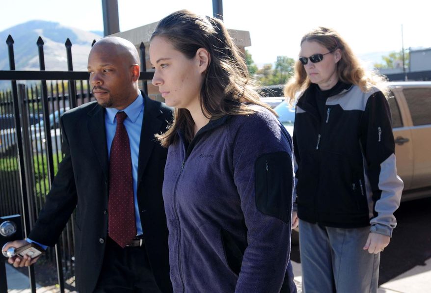 FILE - Jordan Linn Graham, center, leaves the federal courthouse, in this Oct. 4, 2013 file photo taken in Missoula, Mont. The Montana woman who was to be sentenced Thursday for pushing her new husband to his death in Glacier National Park wants to withdraw her guilty plea to a second-degree murder charge, her lawyer said Tuesday March 25, 2014.(AP Photo/The Missoulian, Michael Gallacher, File)