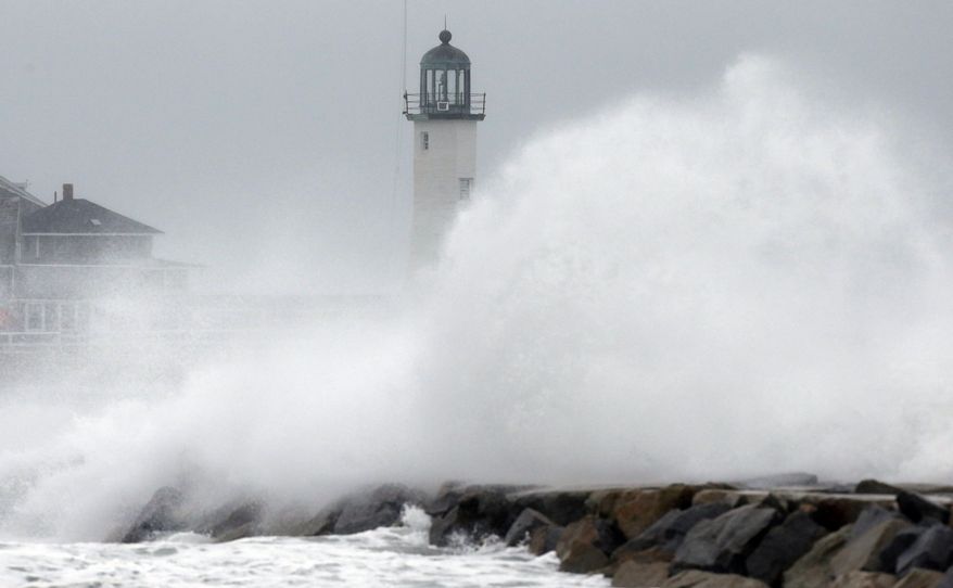 Wind-driven waves crash on a sea wall in Scituate, Mass., Wednesday, March 26, 2014. Cape Cod and the islands were expected to bear the brunt of the spring storm that struck full force Wednesday. The storm could drop up to 10 inches of snow. (AP Photo/Michael Dwyer)