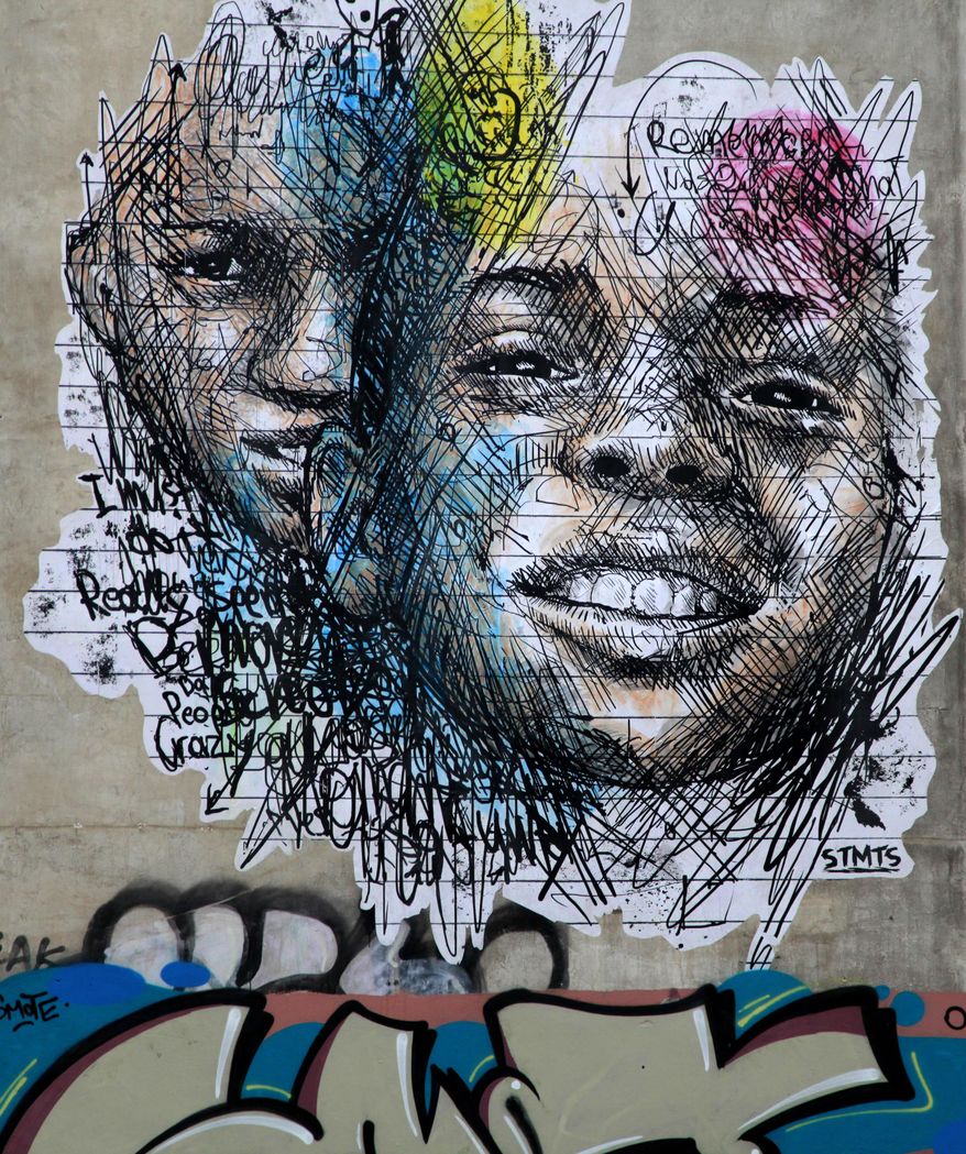 In this photo taken on Monday Feb. 24, 2014,  the work &#39;Moment&#39; by Greek street artist SMTS is seen surrounded by graffiti tags  in the Exarchia are of central Athens. The area, known for its compelling street art, is the frequent site of anti-police and anti-government protests and home to a large anarchist community.  (AP Photo/Dimitri Messinis)