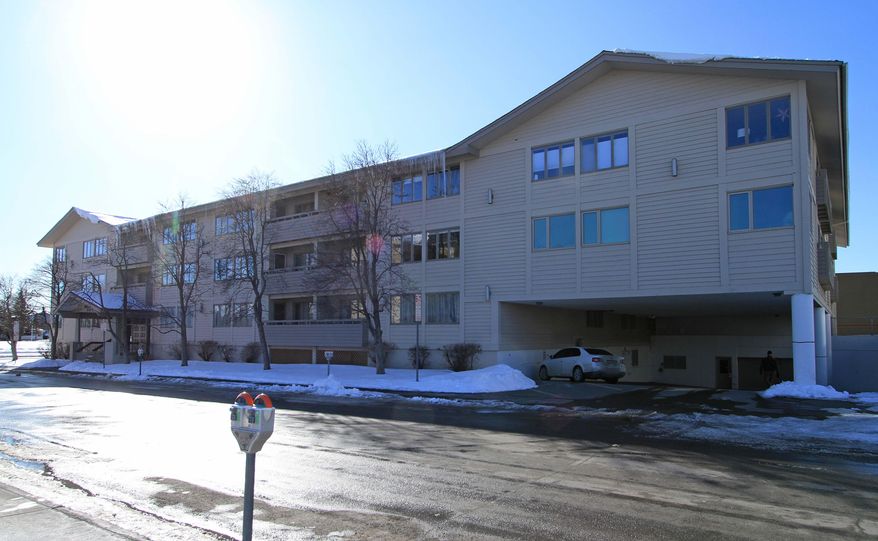 In this photo taken Wednesday March 19, 2014, a four-story apartment complex occupies the site of the six-story Four Seasons Apartments that collapsed in the Great Alaska Earthquake on March 27, 1964, in Anchorage, Alaska. The site at Ninth Avenue and M Street in downtown Anchorage was directly over a graben, or depression, opened by the quake. (AP Photo/Dan Joling)