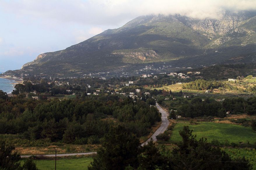 Residence buildings look by the Mediterranean coastline of the Latakia governorate, Syria, Wednesday, March 26, 2014. Syrian rebels pressed their offensive deeper into the coastal heartland of President Bashar Assad's Alawite sect on Wednesday, battling government troops backed by warplanes for control of at least two villages in the heavily wooded and mountainous terrain, activists said. Rebels were battling government troops in the Latakia villages of Qastal Maaf and Nabaain, activists said. (AP Photo)