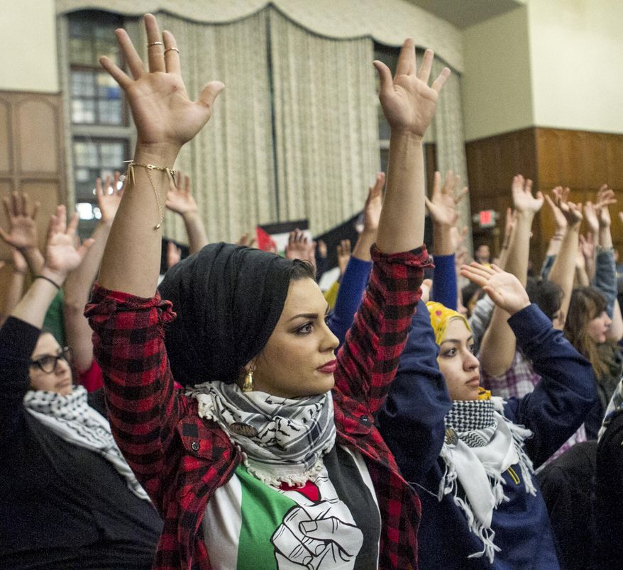 Imaan Ali a Ph.D. student and instructor at the University of Michigan, foreground, is seen during the meeting at the Union at the University of Michigan in Ann Arbor, Michigan Tuesday March 25, 2014. The main point of discussion during the meeting was Divestment from Israel. (AP Photo/The Michigan Daily, Adam Glanzman)