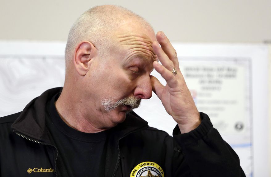 Snohomish County helicopter crew chief Randy Fay pauses briefly as he talks about helping rescue people from the scene of a deadly mudslide days earlier, Wednesday, March 26, 2014, in Arlington, Wash. Sixteen bodies have been recovered, but authorities believe at least 24 people were killed. Scores of others are still unaccounted for. (AP Photo/Elaine Thompson)