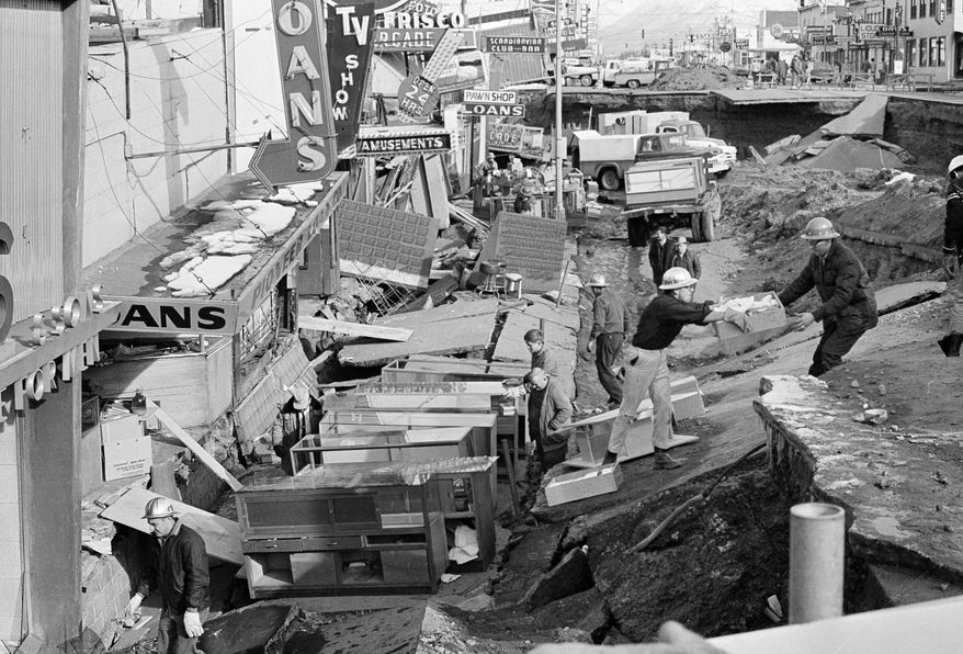 File - In this March 30, 1964 file photo, Anchorage small business owners were going full tilt clearing salvagable items and equipment from their earthquake-ravaged stores on shattered Fourth Avenue in Alaska, in the aftermath of an earthquake. North America's largest earthquake rattled Alaska 50 years ago, killing 15 people and creating a tsunami that killed 124 more from Alaska to California. The magnitude 9.2 quake hit at 5:30 p.m. on Good Friday, turning soil beneath parts of Anchorage into jelly and collapsing buildings that were not engineered to withstand the force of colliding continental plates. (AP Photo, File)