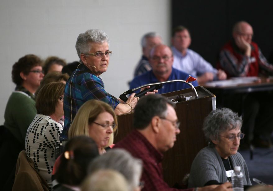 In this photo taken on Tuesday, March 25, 2014, Mary Van Pelt introduces elected officials as Lee County citizens gather at the gymnasium of Central Lee Elementary Junior High School to participate in an informational forum in Donnellson, Iowa. The forum, which was hosted by Mary Van Pelt, addressed the issues of the county budget and having one versus two county seats. (AP Photo/The Hawk Eye, Rachel Jessen)